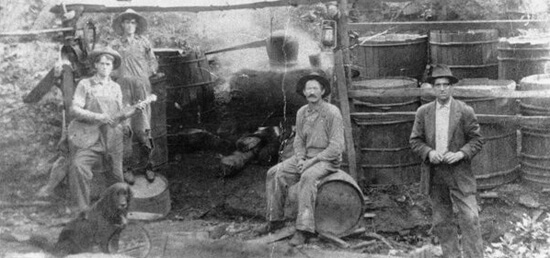 Hosea Thomas' still workers in Endicott, (Franklin County) Virginia, 1915.  The Martin, Rake, and Thomas families trace their origins to Ireland where local residents learned to make liquor (known in Ireland as "potchin") to supplement farm income.  Photo courtesy of the Blue Ridge Institute of Ferrum College. Hosea Thomas' still workers in Endicott, (Franklin County) Virginia, 1915.  The Martin, Rake, and Thomas families trace their origins to Ireland where local residents learned to make liquor (known in Ireland as "potchin") to supplement farm income.  Photo courtesy of the Blue Ridge Institute of Ferrum College.
