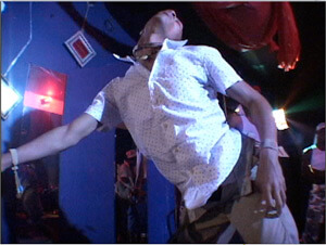 Video still from Ya Heard Me?, Matt Miller and Stephen Thomas, 2008. In the still, a dancer performs at a "sissy shakedown" at Club Vibe, New Orleans, Louisiana, 2004. Video still from Ya Heard Me?, Matt Miller and Stephen Thomas, 2008. In the still, a dancer performs at a "sissy shakedown" at Club Vibe, New Orleans, Louisiana, 2004.