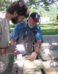 Zachariah McCannon, Searcy County miller Rick Horton discussing local corn varieties with University of Georgia anthropology graduate student James Veteto, Searcy County, 2009. Zachariah McCannon, Searcy County miller Rick Horton discussing local corn varieties with University of Georgia anthropology graduate student James Veteto, Searcy County, 2009.