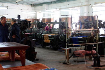 Mary E. Frederickson, As in the mills of the New South, male supervisors oversee the Margilan weave room, Uzbekistan, 2006. Mary E. Frederickson, As in the mills of the New South, male supervisors oversee the Margilan weave room, Uzbekistan, 2006.