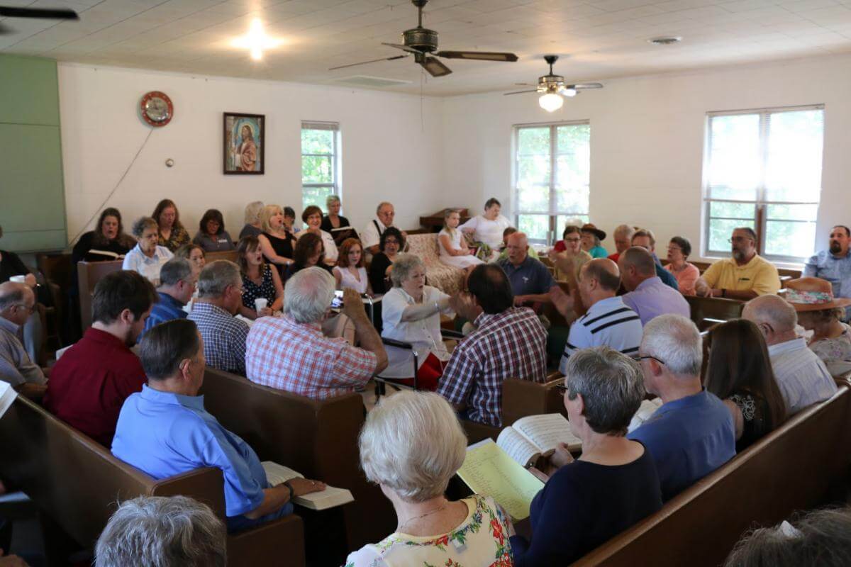 Daphene Causey of Alabaster, Alabama, leads at the 113th session of the Lookout Mountain Sacred Harp Singing Convention, Pine Grove Primitive Baptist Church, Collinsville, Alabama, August 27, 2016. Photograph by James Robert Chambless. Courtesy of the Sacred Harp Museum. Daphene Causey of Alabaster, Alabama, leads at the 113th session of the Lookout Mountain Sacred Harp Singing Convention, Pine Grove Primitive Baptist Church, Collinsville, Alabama, August 27, 2016. Photograph by James Robert Chambless. Courtesy of the Sacred Harp Museum.