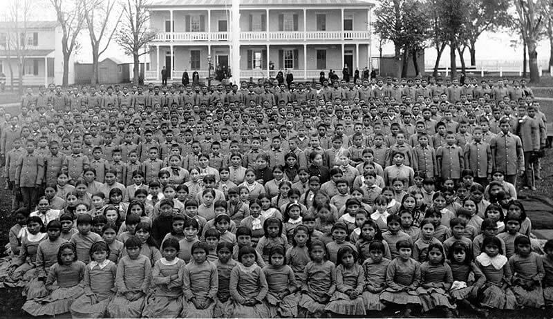 Pupils at Carlisle Indian Industrial School, Pennsylvania, ca. 1900. Photograph by unknown creator. Courtesy of Wikimedia Commons. Image is in the public domain.