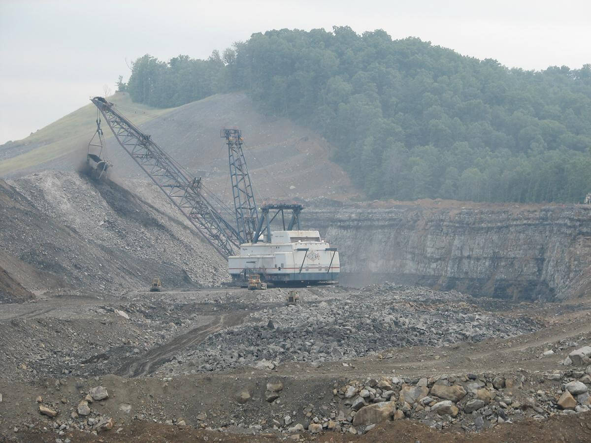 Dragline, West Virginia, ca. 2007. Photograph by Vivian Stockman. Courtesy of Ann Pancake. A photograph of a dragline carrying coal surrounded by rocks and dirt.