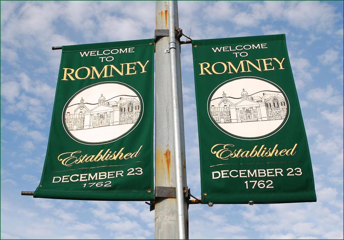 Welcome to Romney, Romney, West Virginia, November 13, 2011. Photograph by Flickr user Ron Cogswell. Creative Commons license CC BY 2.0. Cloth sign reading "Welcome to Romney, Established December 23, 1762" with blue sky in background.