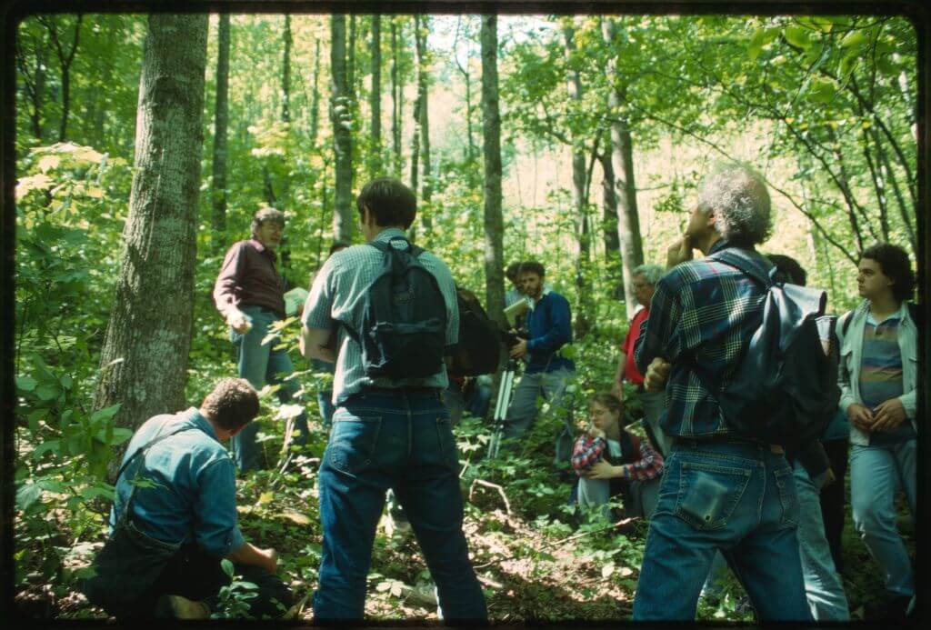 Appalachia Forest Action Project volunteers learning about the land, Rock Creek, West Virginia, May 21, 1994. Photograph by Mary Hufford. Image courtesy of the Library of Congress American Folklife Center.  Photograph of Appalachia Forest Action Project volunteers in a forested area.