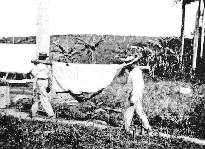 Method of Bringing in Very Ill Patients with a Hammock Case, Puerto Rico, 1911. Originally published in Bailey K. Ashford and Pedro Guitérrez Igaravidez's Uncinariasis (Hookworm disease) in Porto Rico: a medical and economic problem (Washington DC: US Government Print Office, 1911). Image is in public domain. Method of Bringing in Very Ill Patients with a Hammock Case, Puerto Rico, 1911. Originally published in Bailey K. Ashford and Pedro Guitérrez Igaravidez's Uncinariasis (Hookworm disease) in Porto Rico: a medical and economic problem (Washington DC: US Government Print Office, 1911). Image is in public domain.