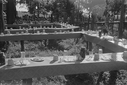Marion Post Wolcott, Table in picnic grove set for St. Thomas church supper, near Bardstown, Kentucky, August 7, 1940. Library of Congress Prints and Photographs Division, FSA/OWI Black & White Negatives Collection, LC-USF33-030983-M5. 