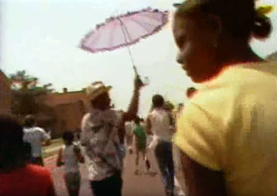 Spyboys singing at the 66th Annual Zulu Parade, New Orleans, Lousiana, May 1982. Footage by Alan Lomax and crew. Courtesy of Alan Lomax YouTube archive. Screenshot by Southern Spaces. Spyboys singing at the 66th Annual Zulu Parade, New Orleans, Lousiana, May 1982. Footage by Alan Lomax and crew. Courtesy of Alan Lomax YouTube archive. Screenshot by Southern Spaces.