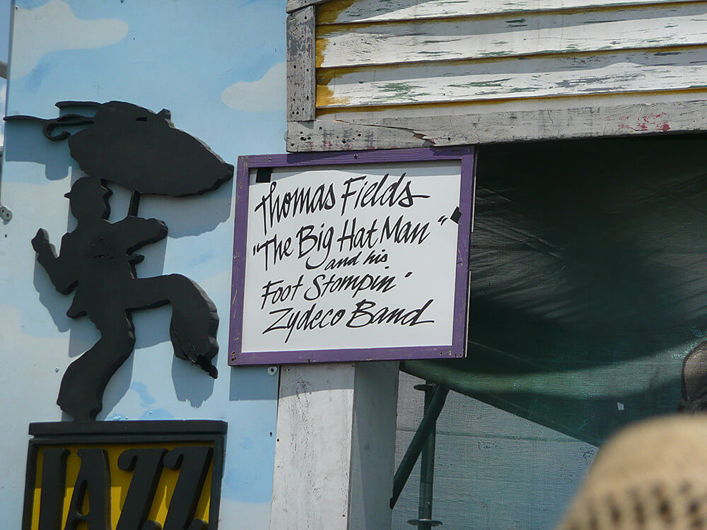Thomas Fields' "The Big Hat Man" and his Foot Stompin' Zydeco Band sign, New Orleans Jazz and Heritage Festival, New Orleans, Louisiana, April 25, 2009. Photograph by Flickr user Rocky A. Creative Commons license CC BY-NC-ND 2.0. Thomas Fields' "The Big Hat Man" and his Foot Stompin' Zydeco Band sign, New Orleans Jazz and Heritage Festival, New Orleans, Louisiana, April 25, 2009. Photograph by Flickr user Rocky A. Creative Commons license CC BY-NC-ND 2.0.