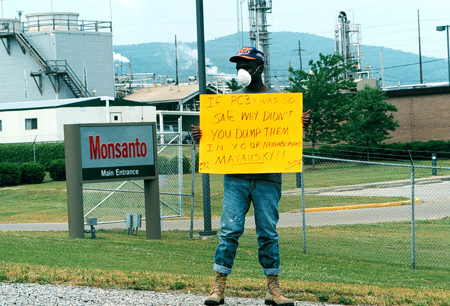 PCB Activist Herman Frazier protests Monsanto's Sweet Valley/Cobbtown relocation plan, Anniston, Alabama, 1996. Photo by Bill Wilson, Anniston Star. Reproduced here from Baptized in PCBs, 76. Courtesy of Ellen Spears. PCB Activist Herman Frazier protests Monsanto's Sweet Valley/Cobbtown relocation plan, Anniston, Alabama, 1996. Photo by Bill Wilson, Anniston Star. Reproduced here from Baptized in PCBs, 76. Courtesy of Ellen Spears.