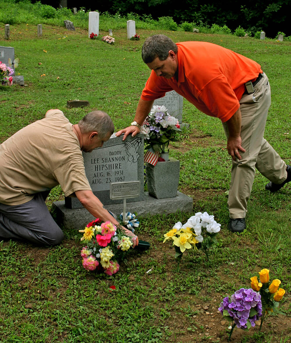 Sons attend the grave of their father, Lee Hipshire, a coal miner and black lung victim. Logan County, WV, 2005. Sons attend the grave of their father, Lee Hipshire, a coal miner and black lung victim. Logan County, WV, 2005.