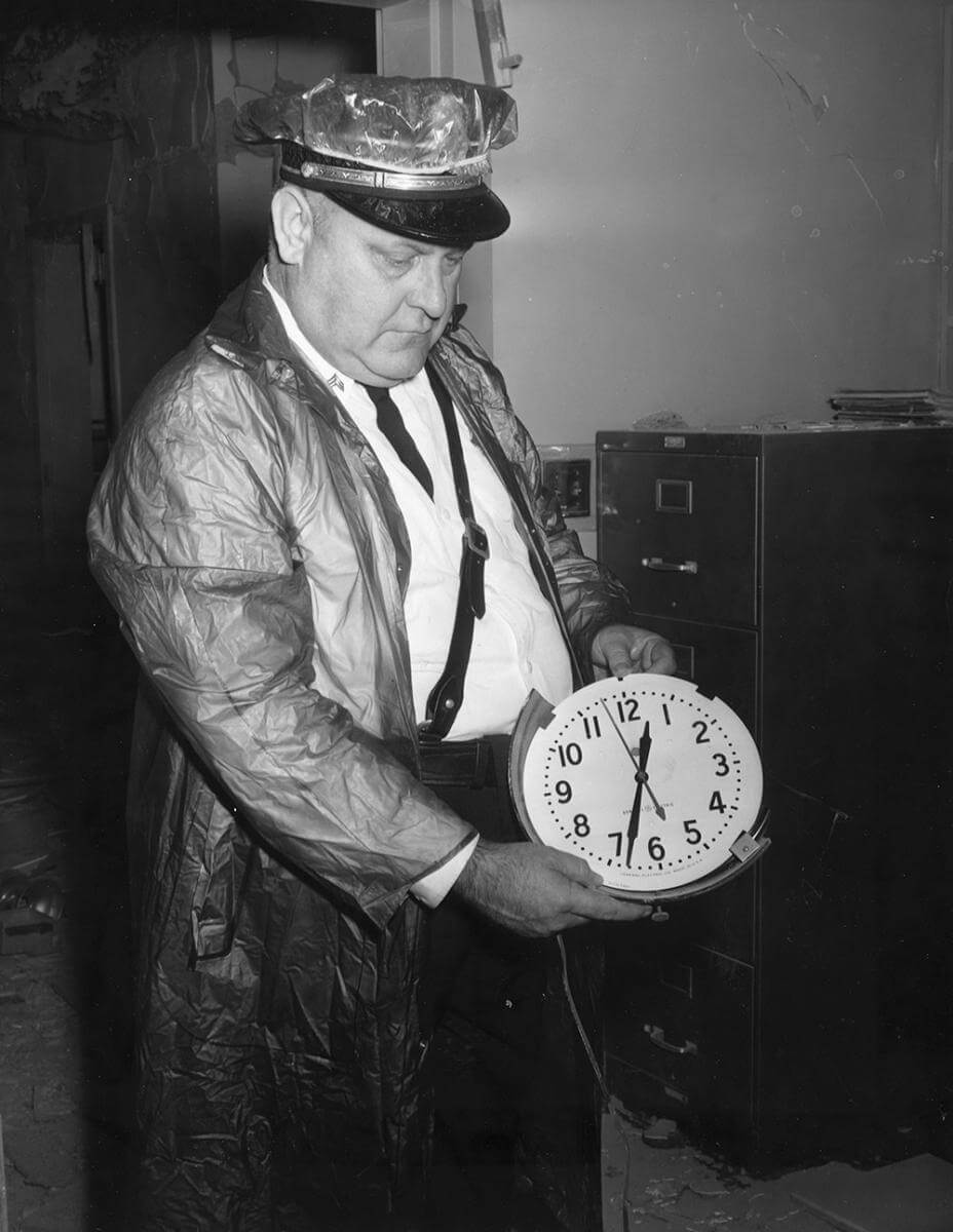 An officer displays a clock stopped at the time of the bomb blast, Nashville, TN, September 1957. © Nashville Public Library. An officer displays a clock stopped at the time of the bomb blast, Nashville, TN, September 1957. © Nashville Public Library.