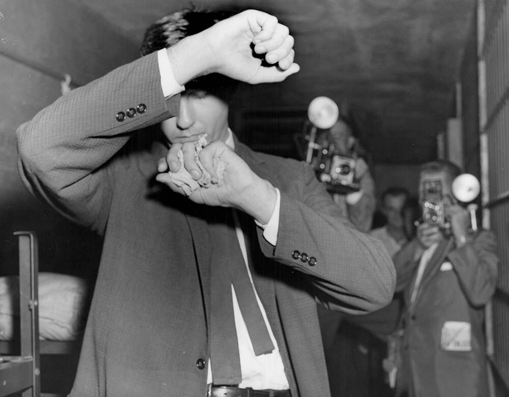 Arrested, John Kasper shields himself from photographers, Nashville, TN, September 1957. © Nashville Public Library. Arrested, John Kasper shields himself from photographers, Nashville, TN, September 1957. © Nashville Public Library.