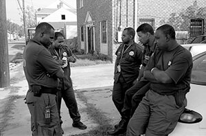 New Orleans police officers, off St. Claude Avenue. New Orleans, Louisiana, October 2005. Photograph by Lewis Watts. Courtesy of Lewis Watts. New Orleans police officers, off St. Claude Avenue. New Orleans, Louisiana, October 2005. Photograph by Lewis Watts. Courtesy Lewis Watts.