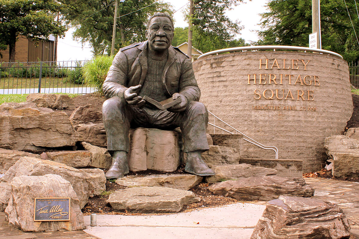 Statue of Roots author Alex Haley in Haley Heritage Square, Knoxville, Tennessee, June 21, 2014. Photograph by Flickr user Brent Moore. Creative Commons license CC BY-NC 2.0.