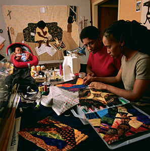 Gwen Magee at work with her daughter Kamili Magee Hemphill and Grandson Ellington Hemphill. Photo courtesy of Roland L. Freeman, 2014. Gwen Magee at work with her daughter Kamili Magee Hemphill and Grandson Ellington Hemphill. Photo courtesy of Roland L. Freeman, 2014.