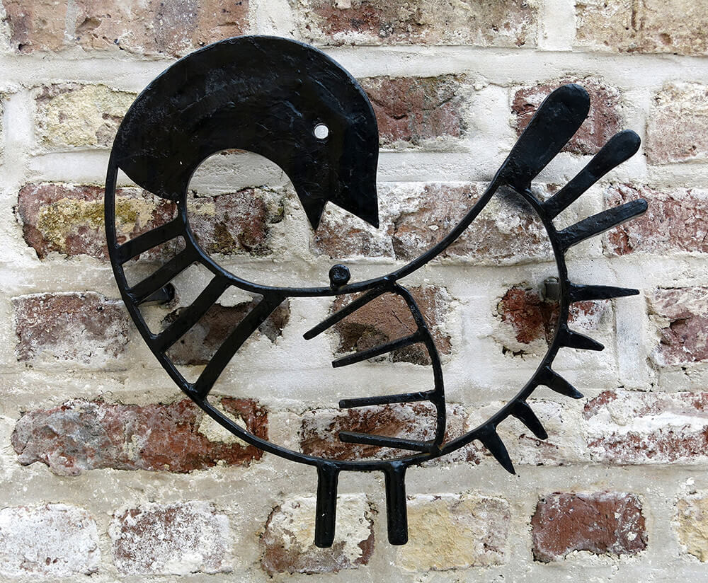 Sankofa symbol honoring the enslaved workers who built the Unitarian Church in Charleston, South Carolina. Monument designed by Paul Garbarini and built by master mason Rodney Prioleau. Carlton Simmons, nephew of renowned blacksmith Philip Simmons, handcrafted the wrought iron sankofa. Photograph by Flickr user Spencer Means. Creative Commons license CC BY-SA 2.0. Sankofa symbol honoring the enslaved workers who built the Unitarian Church in Charleston, South Carolina. Monument designed by Paul Garbarini and built by master mason Rodney Prioleau. Carlton Simmons, nephew of renowned blacksmith Philip Simmons, handcrafted the wrought iron sankofa. Photograph by Flickr user Spencer Means. Creative Commons license CC BY-SA 2.0.