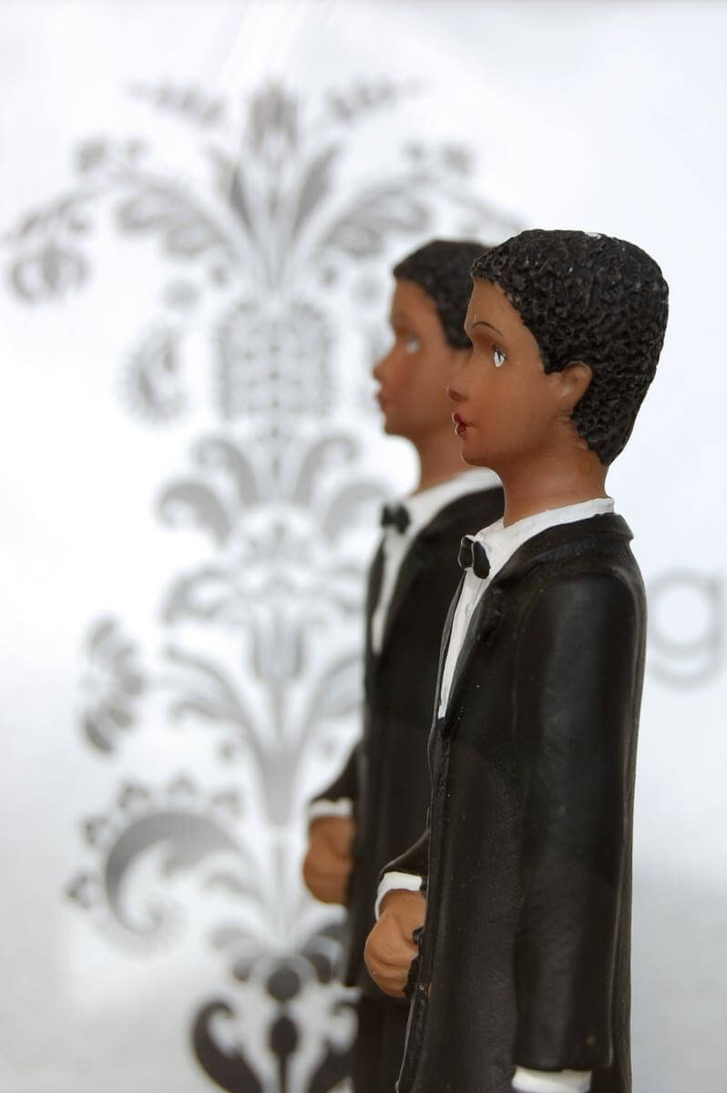 Wedding Cake Figurines, San Francisco, California, October 5, 2008. Photograph by Flickr user Ludovic Bertron. Creative Commons license CC BY 2.0. Photograph of two male cake topper figurines side by side.