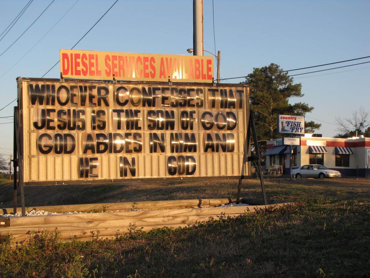 Hope Mills Rapid Lube Sign, Hope Mills, North Carolina, March 20, 2014. Photograph by Flickr user Gerry Dincher. Creative Commons license CC BY-SA 2.0.  Photograph of Hope Mills Rapid Lube Sign, an old changeable letter sign that reads, "Whoever confesses that Jesus is the son of God, God Abides in him and he in God."
