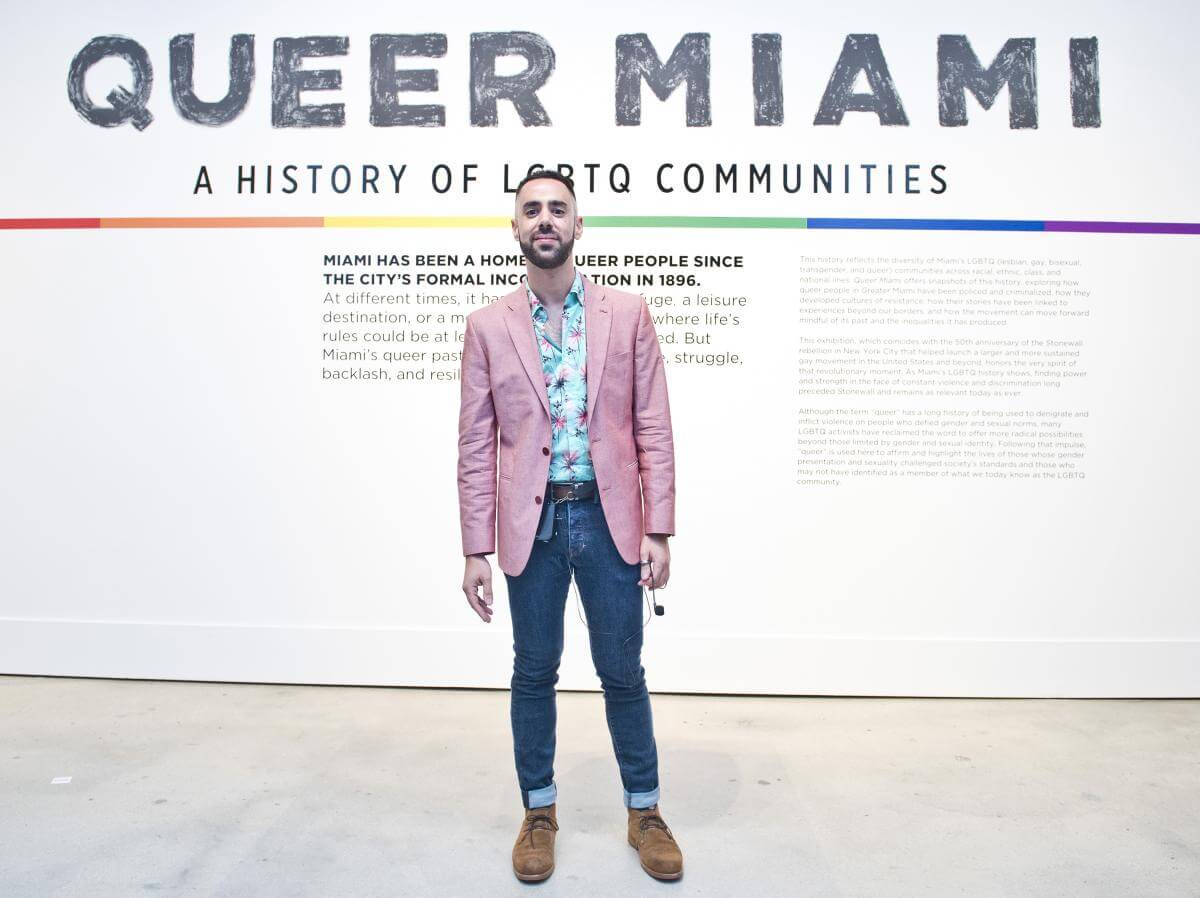 Julio Capó, Jr. during a curator's guided tour of the exhibition Queer Miami: A History of LGBTQ Communities, Miami, Florida, June 6, 2019. Photograph by Michele Reese. Courtesy of Michele Reese, HistoryMiami Museum.