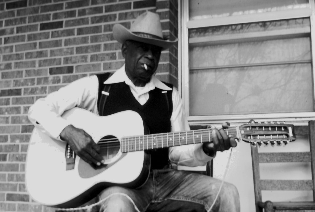 J. W. Warren playing the guitar.